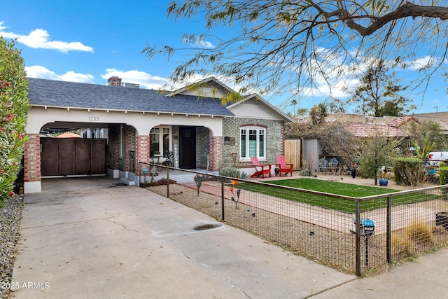 view of front of property with a carport and a front lawn