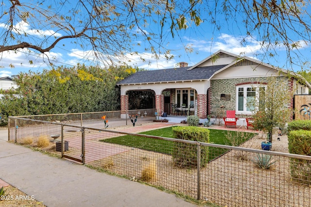 rear view of property featuring a patio and a lawn