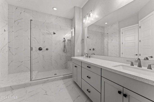 bathroom featuring a tile shower and vanity