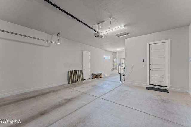 garage with water heater and a garage door opener