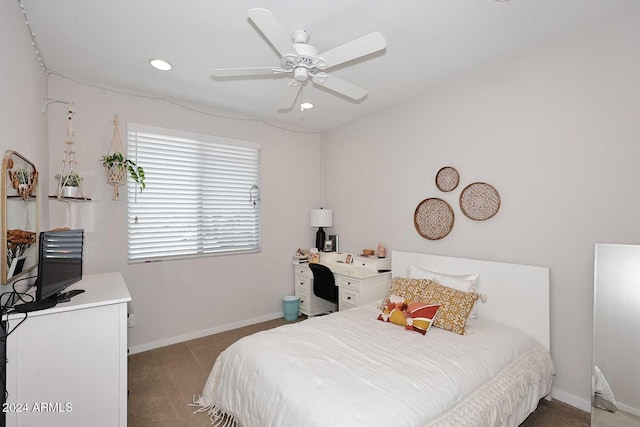 bedroom with ceiling fan and dark carpet