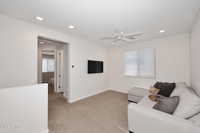 living room featuring light carpet and ceiling fan