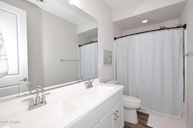 bathroom featuring hardwood / wood-style floors, vanity, and toilet