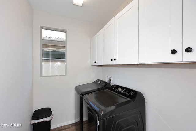 clothes washing area featuring cabinets, independent washer and dryer, and dark wood-type flooring