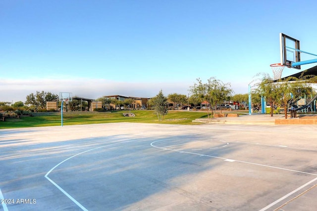 view of sport court with a lawn