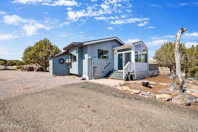 view of front of home with a sunroom