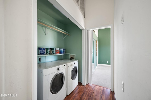 laundry area with dark wood-type flooring and washer and dryer