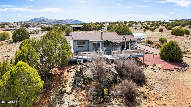 back of house featuring a deck with mountain view
