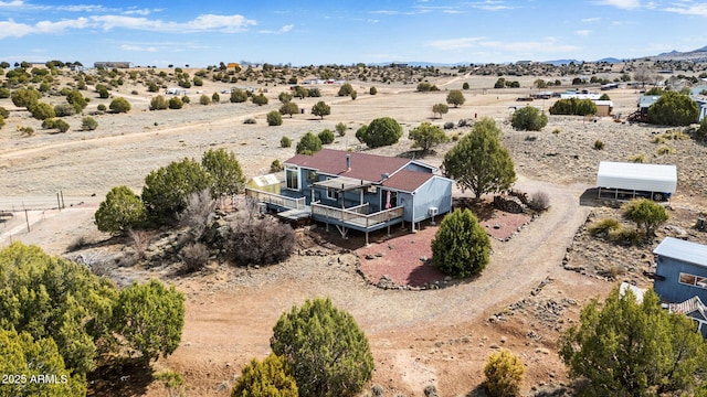 drone / aerial view featuring a rural view and view of desert
