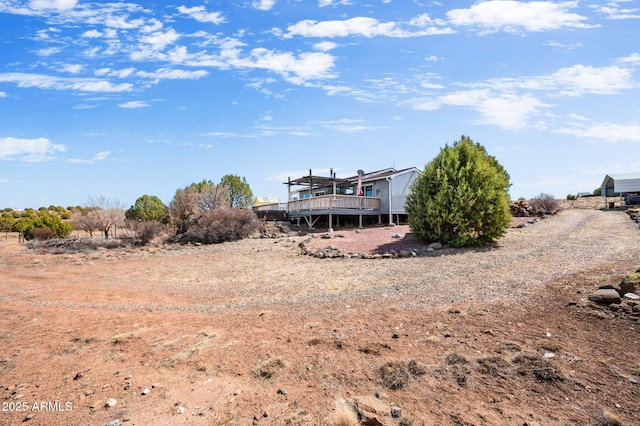 rear view of property featuring a deck