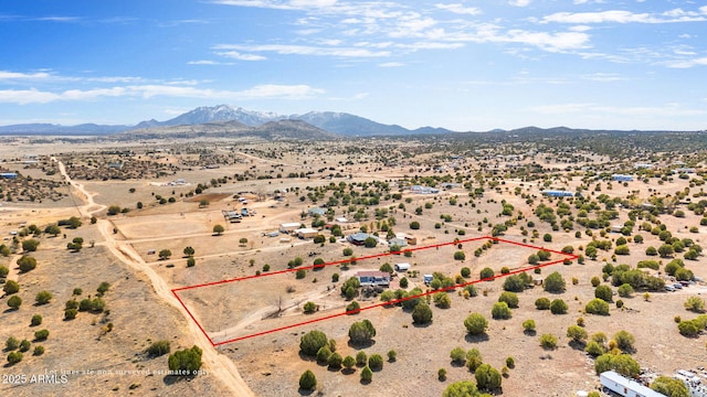 drone / aerial view featuring a mountain view, a rural view, and view of desert