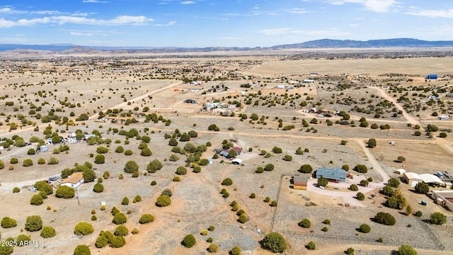 bird's eye view featuring a mountain view, a desert view, and a rural view