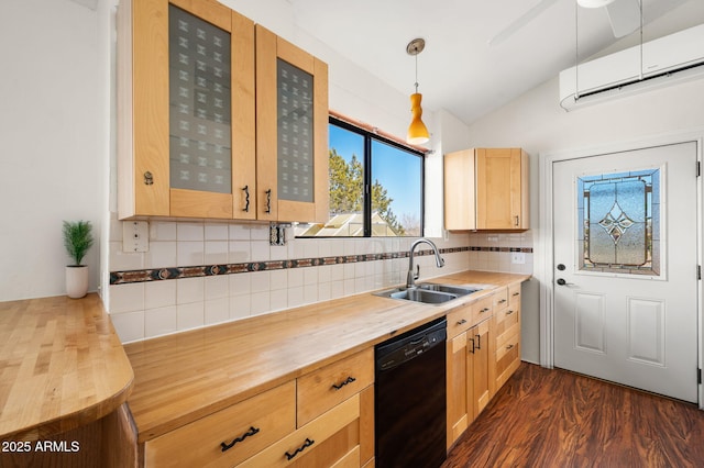 kitchen with vaulted ceiling, light brown cabinetry, a sink, butcher block counters, and black dishwasher