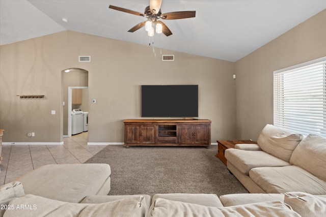 20464 E Bronco Dr, Queen Creek, AZ 85142 - living room with washing machine and dryer, vaulted ceiling, a ceiling fan, arched walkways, and light tile patterned flooring