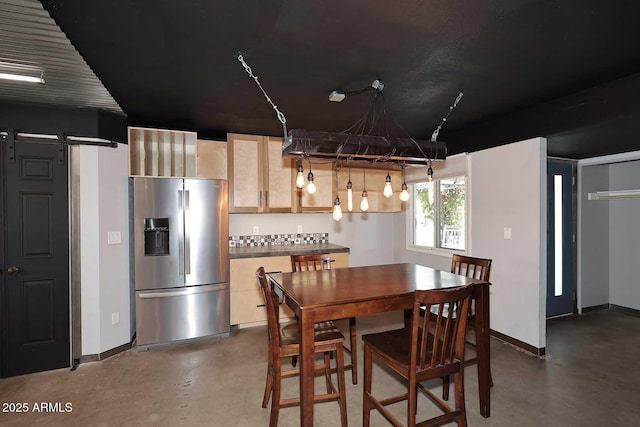 5634 N 39th Ave, Phoenix, AZ 85019 - dining space with concrete flooring, baseboards, and a barn door
