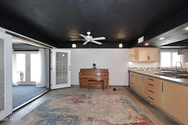 5634 N 39th Ave, Phoenix, AZ 85019 - kitchen with stainless steel gas cooktop, light brown cabinets, french doors, ceiling fan, and finished concrete floors