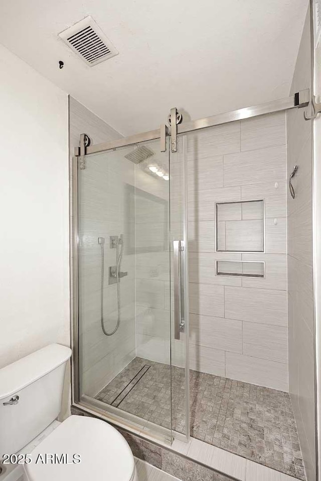 5634 N 39th Ave, Phoenix, AZ 85019 - bathroom featuring visible vents, a stall shower, and toilet