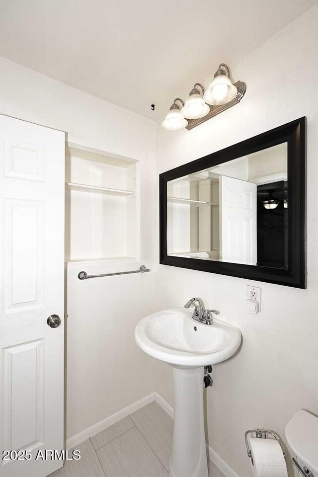 5634 N 39th Ave, Phoenix, AZ 85019 - bathroom with baseboards, tile patterned flooring, and toilet
