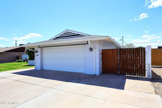 5634 N 39th Ave, Phoenix, AZ 85019 - garage featuring concrete driveway, fence, and a gate