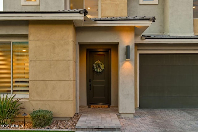 view of exterior entry featuring a garage