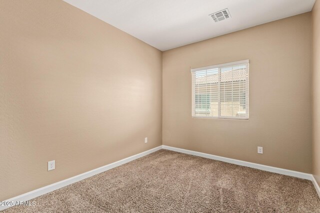 unfurnished room featuring carpet floors, baseboards, and visible vents