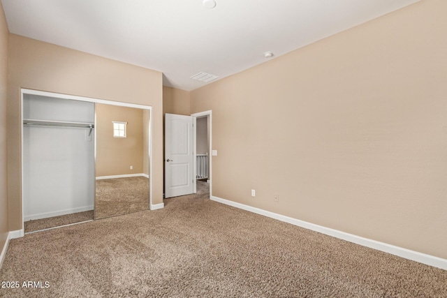 unfurnished bedroom featuring carpet flooring, a closet, visible vents, and baseboards