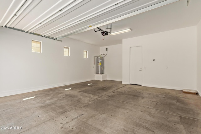 garage with baseboards, water heater, and a garage door opener