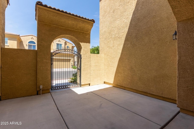 view of gate with a patio area and fence