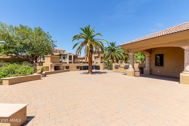 exterior space featuring area for grilling, a patio, and a residential view