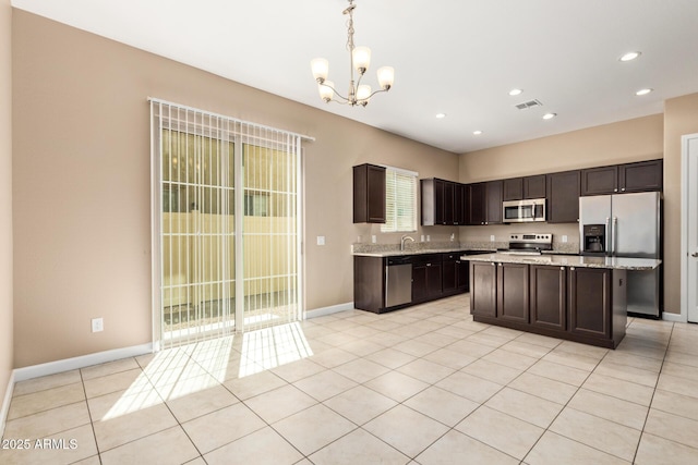 kitchen featuring dark brown cabinetry, an inviting chandelier, visible vents, and appliances with stainless steel finishes