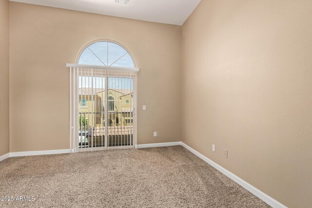spare room featuring baseboards and carpet floors