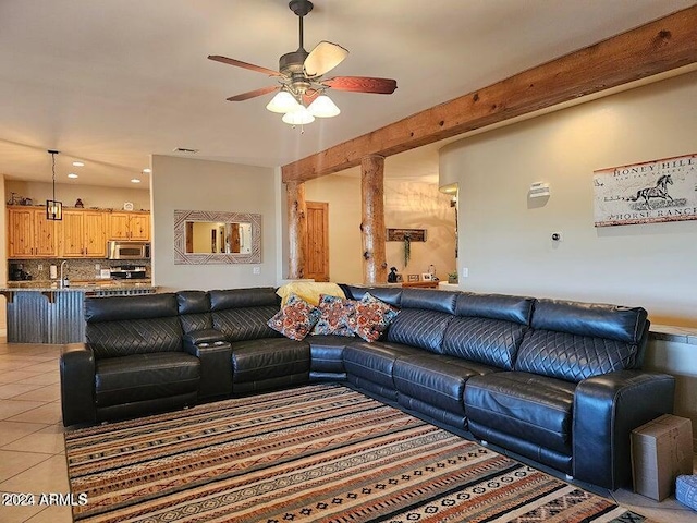 living room featuring light tile patterned floors, ceiling fan, and sink