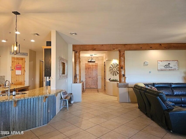 living room with light tile patterned flooring, lofted ceiling, and sink