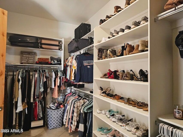 walk in closet featuring light tile patterned flooring