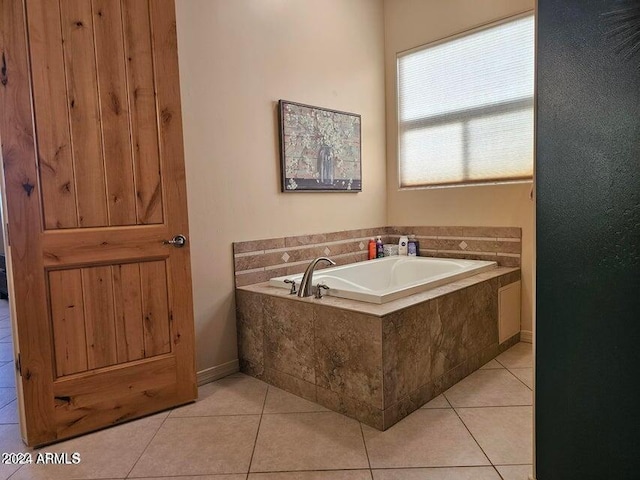 bathroom featuring tile patterned floors and tiled bath