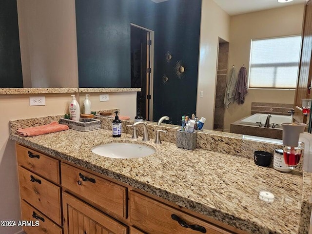 bathroom with vanity and a tub