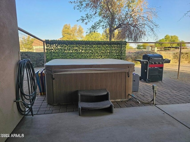 view of patio / terrace featuring area for grilling and a hot tub