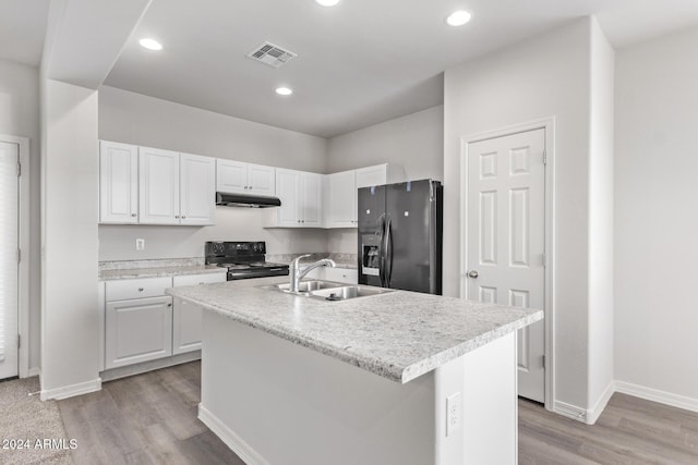 kitchen featuring black appliances, a center island with sink, white cabinets, sink, and light hardwood / wood-style flooring