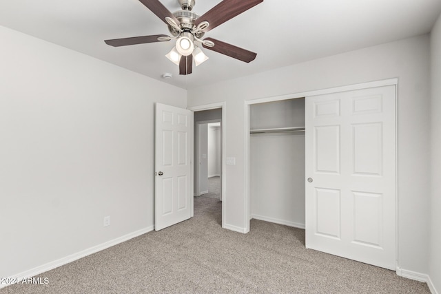 unfurnished bedroom featuring ceiling fan, light carpet, and a closet