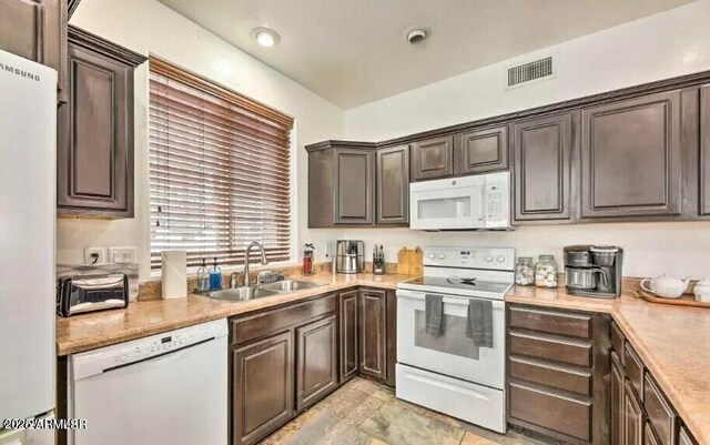 2600 W Old Linden Rd, Show Low, AZ 85901 - kitchen featuring white appliances, a sink, light countertops, and dark brown cabinetry