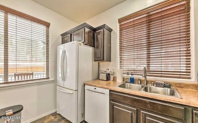 2600 W Old Linden Rd, Show Low, AZ 85901 - kitchen featuring white appliances, a sink, dark brown cabinets, light countertops, and baseboards
