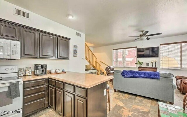 2600 W Old Linden Rd, Show Low, AZ 85901 - kitchen featuring white appliances, open floor plan, ceiling fan, a peninsula, and light countertops