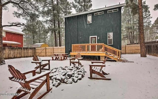 2600 W Old Linden Rd, Show Low, AZ 85901 - snow covered rear of property featuring a fenced backyard, a wooden deck, and a patio area