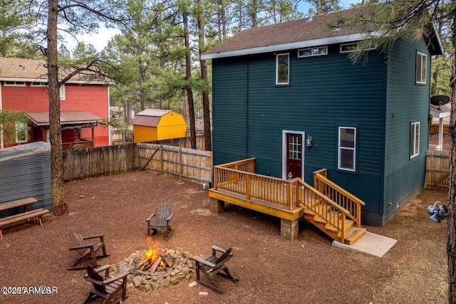 2600 W Old Linden Rd, Show Low, AZ 85901 - back of property with an outdoor fire pit, a fenced backyard, and a deck
