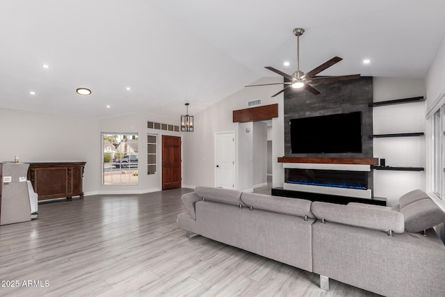 unfurnished living room featuring visible vents, ceiling fan with notable chandelier, wood finished floors, a fireplace, and baseboards