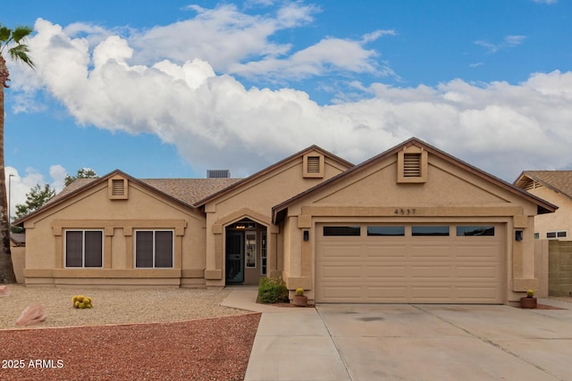 single story home featuring stucco siding, driveway, and a garage