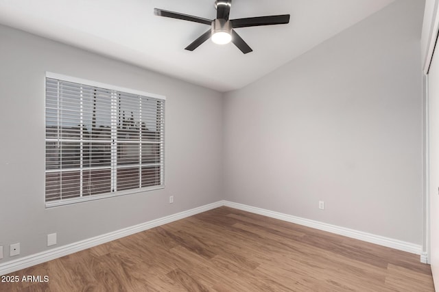 empty room featuring baseboards, ceiling fan, and wood finished floors