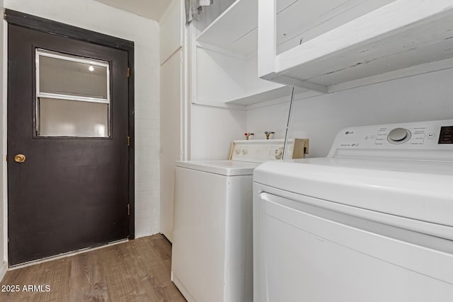10001 W Caron Dr, Sun City, AZ 85351 - washroom with washer and clothes dryer and wood finished floors