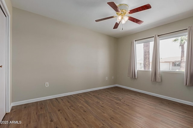 10001 W Caron Dr, Sun City, AZ 85351 - unfurnished room with wood finished floors, baseboards, and a ceiling fan