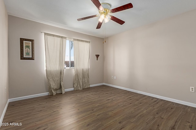 10001 W Caron Dr, Sun City, AZ 85351 - spare room featuring wood finished floors, ceiling fan, and baseboards